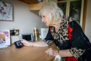 An elderly woman who knows how to use device for smart meters